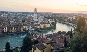 Sonnenuntergang über Verona: malerischer Blick auf die Etsch, die Ponte Pietra und den Torre dei Lamberti. Ein perfekter Ort für Sightseeing in Verona.