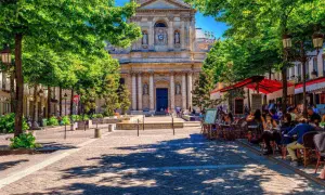Ein sonniger Tag in Paris, mit Menschen, die in Cafés sitzen. Perfekt für alle unter 26, die Paris kostenlos erleben wollen.