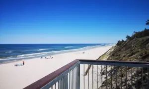 Ein einsamer Strand an der polnischen Ostsee, ein echter Geheimtipp. Weißer Sand, blaues Meer und ein klarer Himmel.