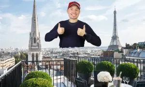 Mann mit Daumen hoch vor Pariser Skyline, mit Eiffelturm und Kirchturm. Ein Traum von der Avenue Montaigne.