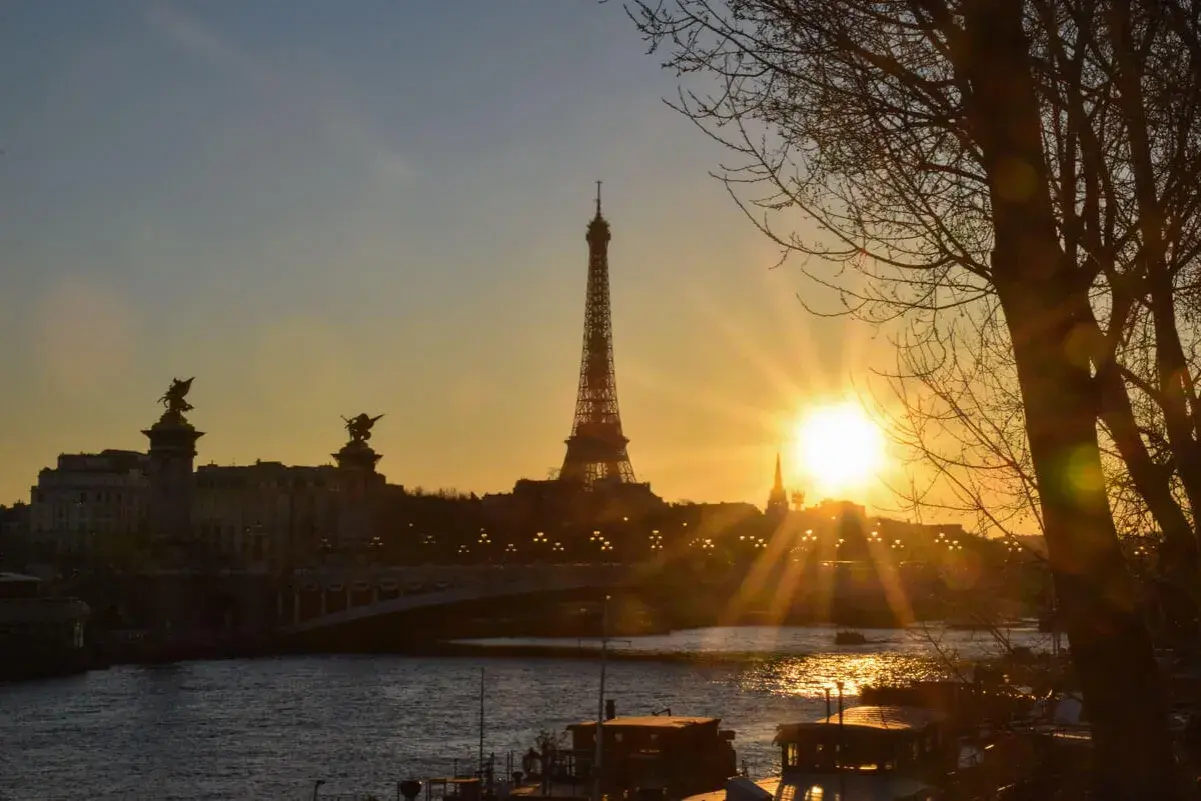 Sonnenuntergang über Paris mit Eiffelturm und Seine. Tolle Tipps für Ihren Paris-Besuch bei diesem Anblick.