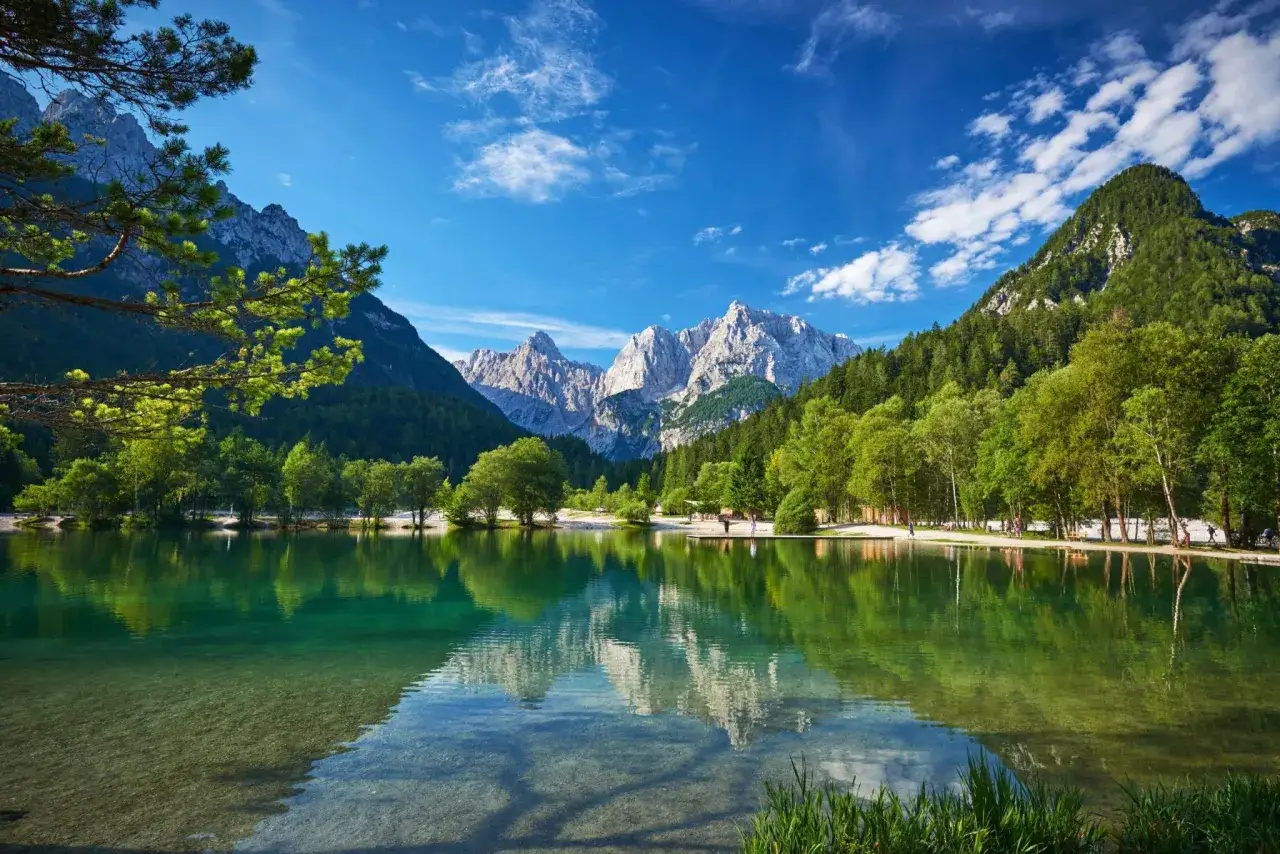 Kranjska Gora: Türkisgrüner See spiegelt majestätische Berge wider. Perfekt für eine Wanderung in dieser idyllischen Landschaft.